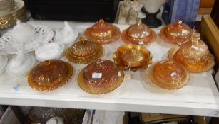 Various marigold carnival glass butter dishes including one from the Marion Quintin-Baxendale