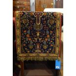 Small fringed rug with stylised floral pattern within a yellow ground border