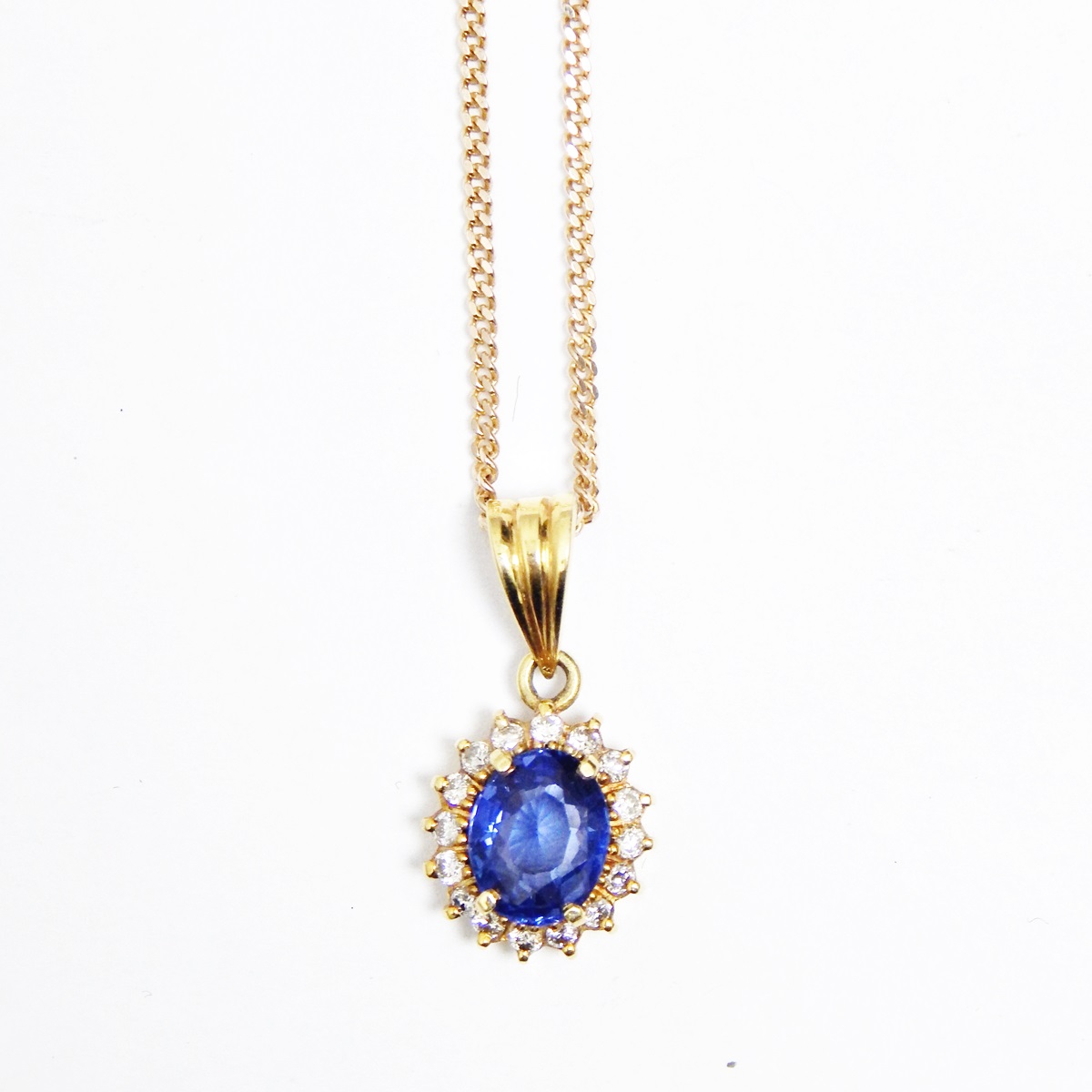 Gold, sapphire and diamond pendant, oval, set oval sapphire surrounded by small diamonds,