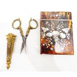 Tortoiseshell and mother-of-pearl card case and a pair of gold-coloured metal scissors in leather