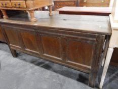 18th century oak coffer with two plank top, four-panelled front on stile supports,