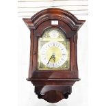 German mahogany-cased wall clock with arched pediment, brass and silvered dial,