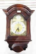 German mahogany-cased wall clock with arched pediment, brass and silvered dial,