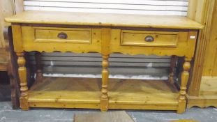 Pine dresser base fitted with two drawers, over turned supports,