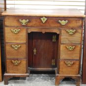 Late 18th/early 19th century mahogany kneehole desk having an arrangement of seven drawers and with