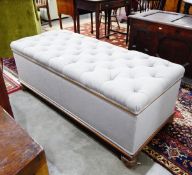 Early 20th century ottoman having deep button padded seat and on turned bun feet,
