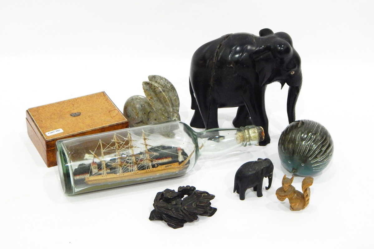 Quantity of carved wood ebony elephants and other animals, soapstone model of a bottle in a ship,
