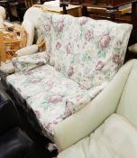 Cottage style wing-side two seat settee with floral patterned loose covers,