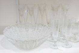 Five cut glass wine glasses and a set of four early 20th century knopped stem faceted champagne