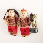 Two small Chinese dolls and a Tom and Jerry plastic toy
