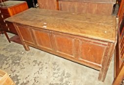 18th century oak coffer with two plank top, four-panelled front on stile supports,