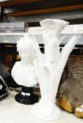 White ceramic stand in natural form of a lily supporting the white ceramic bust of a Victorian