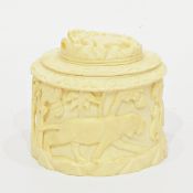 Early 20th century carved ivory cylindrical caddy/box with lion decoration to lid and lion hunting