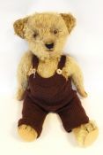 Old mohair teddy bear with glass eyes, sewn mouth and nose, jointed limbs,