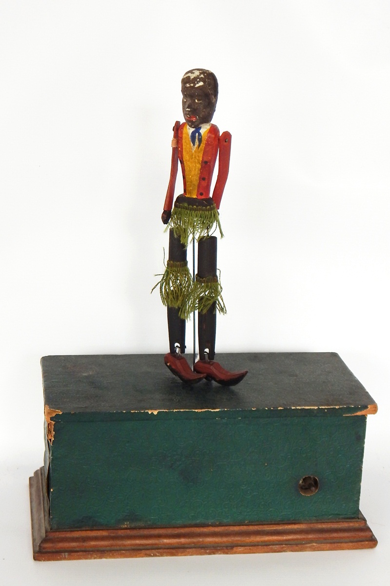 Perry & Co painted wooden automaton 'Negro' dancer with painted wooden base containing movement and