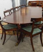 Regency-style mahogany twin-pillar extending dining table having two extra leaves and on turned