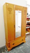 Edwardian wardrobe with bevelled mirror panelled door and with carved ornamentation and drawer to