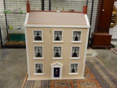 20th century wooden double-fronted doll's three storey dolls house in the Georgian-style together