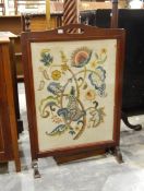 Early 20th century crewelwork and mahogany gratescreen,