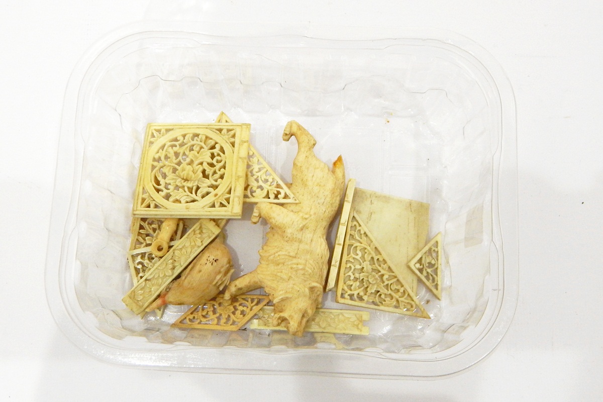 Quantity of worked bone and ivory pieces including pierced foliate panels, model of a lion, etc.