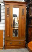 Edwardian single mirror-door wardrobe over single drawer base,