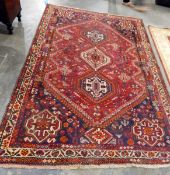 Caucasian-style wool carpet with triple-octagonal arabesque totem to the red field,