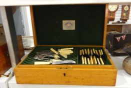 Oak table canteen containing sundry EPNS and yellow-handled table flatware,