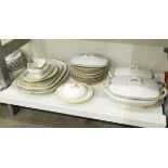 Limoges part dinner service comprising tureens, serving plates, dinner plates, gravy boat etc.