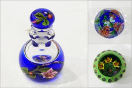 John Deacons scent bottle having blue ground with lampwork flower and ladybird to base and stopper,