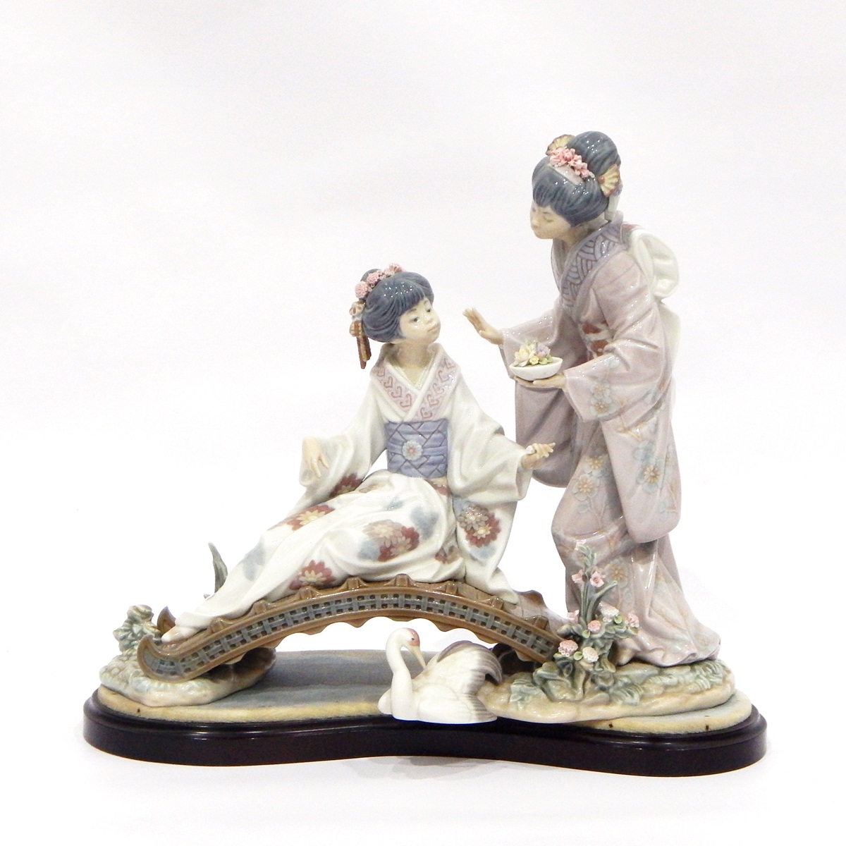 Lladro porcelain figure group of two Japanese geisha girls on a bridge with stork on a plinth base,