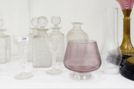 Three strawberry cut square-shaped decanters, a pair of tapering cut bottles lacking stopper,