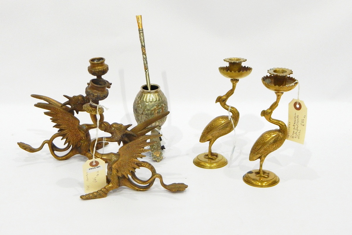 Pair of brass crane-pattern candle holders, each on circular base,