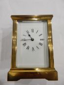 Brass carriage timepiece in reeded case with cavetto cornice, shaped handle,