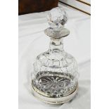 Cut glass and silver-mounted wine decanter with bulbous body and the facet-cut stopper and the