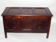 Antique oak blanket chest having geometric moulded panelled front and on stile feet,