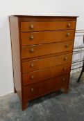 Oak chest of six long graduated drawers, having brass flowerhead pattern, pierced brass finish,