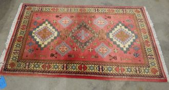 Eastern wool rug with triple stepped arabesque totem to the cherry red field, cream ground,