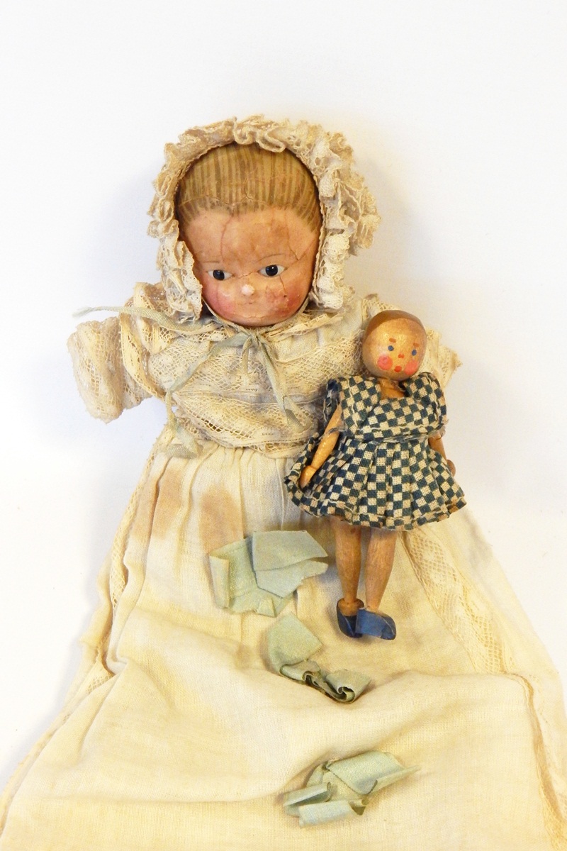 Late Victorian papier mache doll with painted hair and face with glass bead eyes,