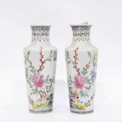 Pair of Oriental porcelain vases, with tall flared necks and circular tapering form,