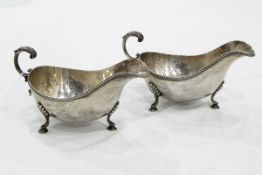 Pair of Georgian style silver sauce boats, each with gadrooned border, double C-scroll handle,