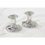 Pair of sterling silver candle holders on circular bases,