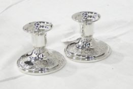 Pair of sterling silver candle holders on circular bases,