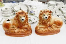 Pair of Staffordshire pottery lion ornaments,