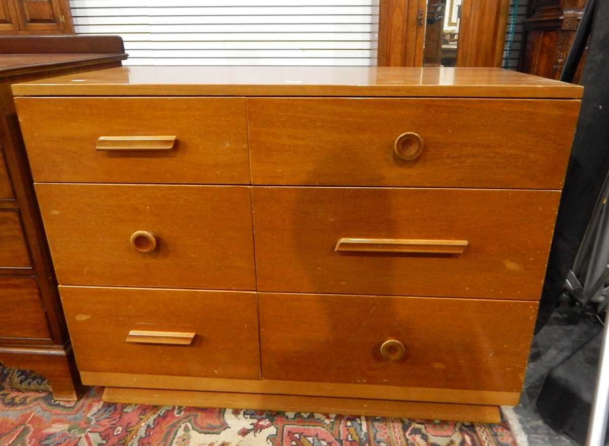 Polished solid wood chest of six short drawers, three of which have turned knob handles,