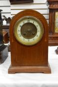 Edwardian mahogany dome-cased mantel clock, with enamelled chapter ring and striking movement,