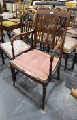 Edwardian inlaid mahogany elbow chair with cane and fret carved panelled back,