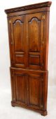 Reproduction 18th century oak standing corner cupboard enclosed by field panelled doors under a
