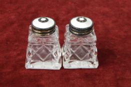 Pair of Norwegian silver, cut glass and enamel miniature salt shakers of square tapered form,