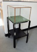 Black painted wood and glazed table display cabinet having glazed box top with green baize lining,