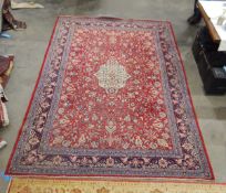 Persian Sarough wool carpet with ivory central medallion to the cherry red field,